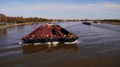 Aerial-Shot-From-Forward-Bow-Of-Empty-Barges-Being-Pushed-By-Veerhaven-Tug-Along-Oude-Maas