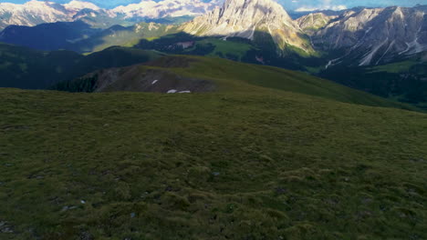 Grassland-meadow-aerial-view-revealing-solitary-South-Tyrol-Peitlerkofel-sunlit-mountain-peak
