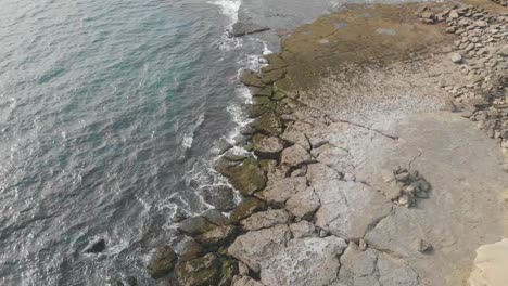 Aerial-View-Of-Cracked-Rocky-Coastline-Beside-Gulf-Of-Oman-In-Jiwani