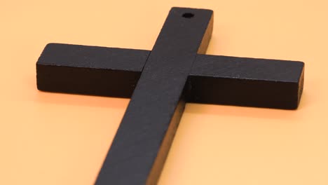 Christian-cross-made-of-black-wood,-macro-shot