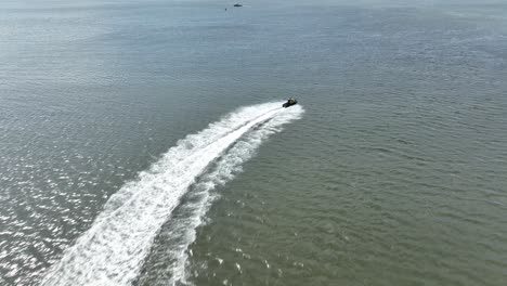 An-aerial-view-over-Gravesend-Bay-in-Brooklyn,-NY-as-a-jet-skier-enjoys-the-beautiful-day