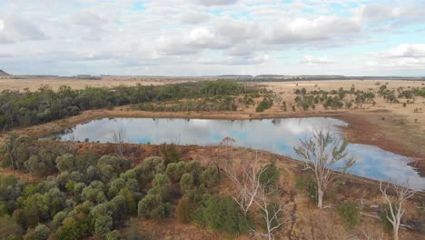 Überblick-Drohnenaufnahme-Eines-Stausees-Im-Outback-In-Australien-Mit-Spiegelungen-Im-Wasser