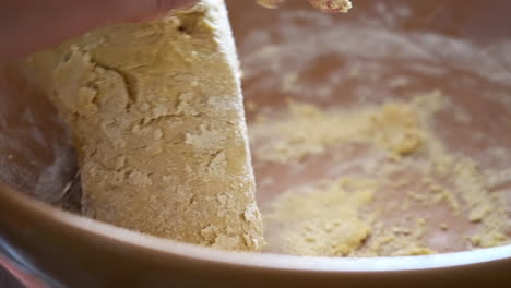 Hand-Kneading-and-Mixing-Gently-Floured-Ingredients-in-Bowl-to-Make-Dough,-Preparation-for-Homemade-Baking-Cookies-Biscotti-Cantucci,-Close-Up-View