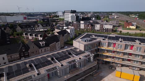 Aerial-backwards-movement-and-reveal-of-Ubuntuplein-under-construction-in-urban-development-real-estate-investment-project-in-new-Noorderhaven-neighbourhood