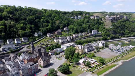 Aerial-flying-drone-shot,-tracking-in,-of-the-Rhine-River-Valley-and-Old-Architecture---including-medieval-castles,-old-buildings,-and-natural-forested-alpine-hills
