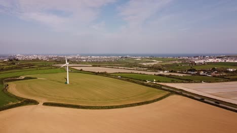 Wind-turbine-spinning-amidst-green-countryside-in-the-UK-3