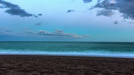 Dreamy-long-exposure-coastal-sunset-time-lapse,-cloud-transformations