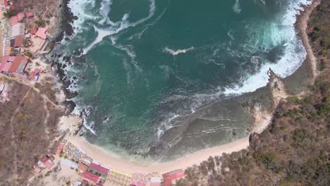 Drone-flying-over-the-island-of-Ixtapa-located-in-the-state-of-Guerrero,-Mexico-during-a-sunny-day