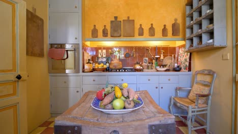 Small-kitchen-station-at-a-villa-with-colorful-vegetables-and-rustic-decoration,-Dolly-in-shot