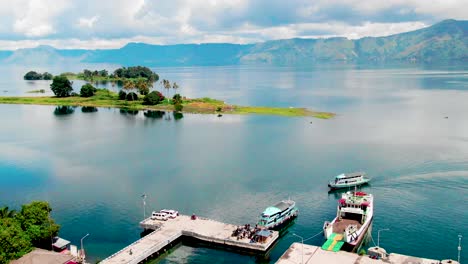 Aerial-Footage-of-a-Dock-along-the-clear-waters-of-Lake-Toba,-Sumatra