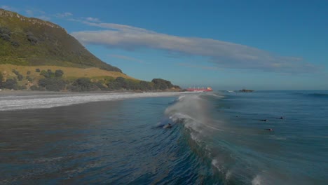AERIAL:-Surfers-at-Mount-Maunganui-Beach,-New-Zealand