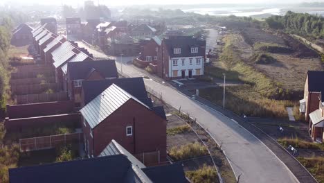 Aerial-view-during-morning-sunrise-over-British-housing-estate-development-building-site