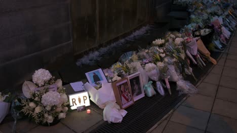 A-sign-with-the-word-RIP-next-to-a-flower-bouquet-outside-the-British-Consulate-General-as-a-tribute-after-the-passing-of-the-longest-serving-monarch-Queen-Elizabeth-II