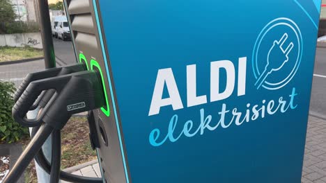 Charger-and-plugs-for-electric-vehicle-at-Aldi-charging-station-Cologne,-Germany-Editorial-use-only