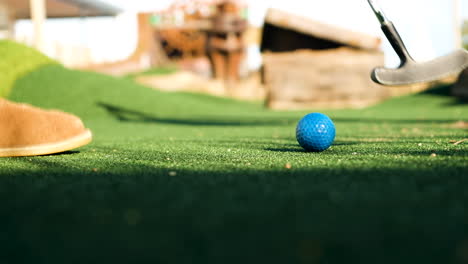Man-playing-minigolf-makes-a-putt-on-the-putting-green