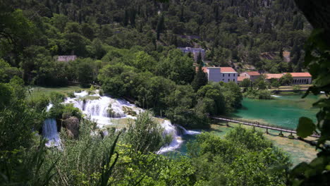 Forest,-waterfalls-and-houses-in-Krka-National-Park,-Croatia,-wide-pan