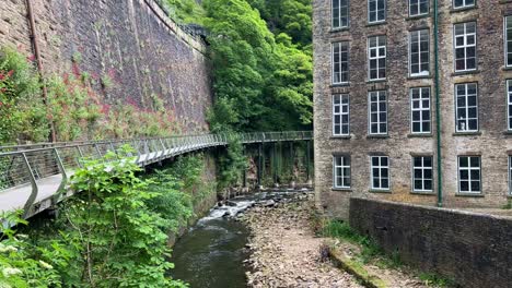 The-Millennium-Walkway-in-the-town-of-New-Mills-with-the-Goyt-river-running-through-the-video-and-the-Torr-Vale-Mill-on-the-right