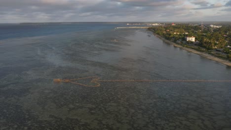 Aerial-flyover-of-arrow-shaped-fishing-structure-on-a-shallow-reef-in-Tonga