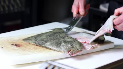 Raw-turbot-fish-getting-cleaned-up-and-cut-in-fillet-at-a-fish-a-fish-vendor-establishment