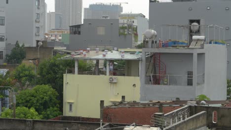 Man-Securing-Top-of-Terrace-For-Incoming-Typhoon-Noru,-Da-Nang-City,-Vietnam
