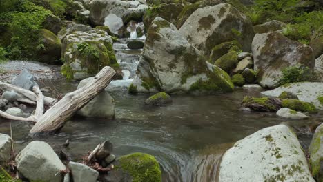 Mossy-Rocks-and-River-Flowing-Through-Mountains-of-Tottori,-Mt-Daisen