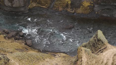 Stream-flowing-in-Fjadrargljufur-Canyon,-Iceland.-High-angle