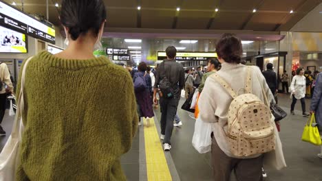 Handheld-Walking-POV-Aufnahme,-Als-Menschenmassen-Zu-Einer-Der-Größten-Bahnhöfe-Von-Kansai-Gehen