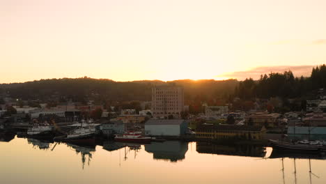 Coos-Bay-Oregon-at-sunset,-drone-flies-over-bay-from-left-to-right
