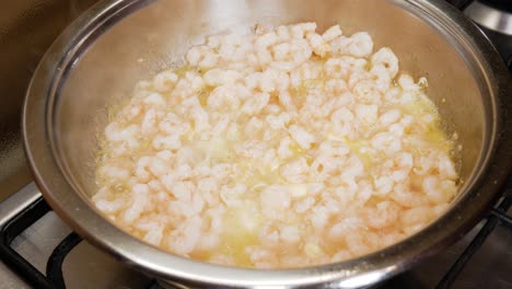 Fresh-small-shrimps-cooking-on-butter-sauce-in-silver-hot-pot