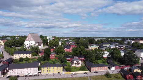 Aerial-pan-shot-over-historic-town-of-Porvoo-in-Finland-during-sunny-day-showing-beautiful-buildings-and-trees
