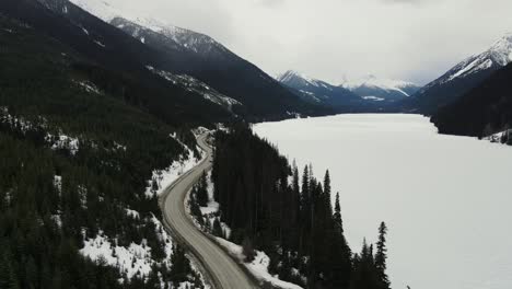 Aerial-drone-shot-of-frozen-Duffey-Lake-in-British-Columbia,-Canada