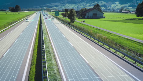 Time-lapse-of-busy-highway-with-digital-lane-assist-lines-through-green-mountain-landscape
