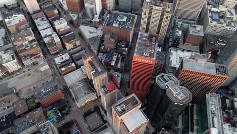 Aerial-view-overlooking-sunlit-skyscrapers-in-Downtown-Pittsburgh---tilt,-drone-shot