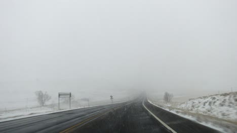 POV-footage-of-driving-in-the-countryside-of-Boulder,-Colorado-during-a-snowstorm
