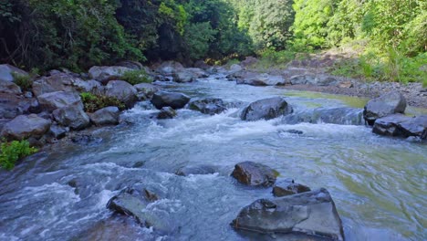 Stones-In-River-Water---Summer-Nature-Scene-At-Rio-Higuero,-Dominican-Republic---aerial-drone-shot