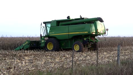 A-combine-moves-away-right-to-left-harvesting-corn
