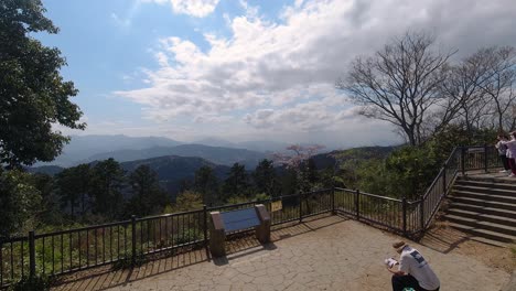 Many-hikers-enjoying-view-from-top-of-Mount-Takao-in-Tokyo,-Japan---Time-Lapse