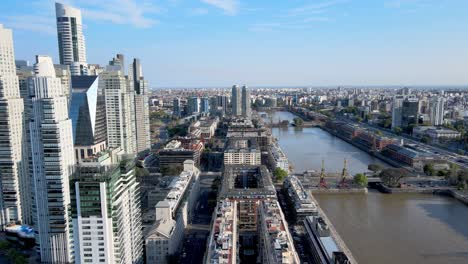 Aerial-flying-over-Puerto-Madero-neighborhood-with-the-skyline-on-the-left-in-Buenos-Aires