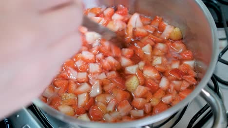 Preparing-strawberry-jam,-stirring-boiling-pot,-slow-motion