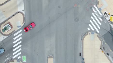 Aerial-view-of-a-cars-on-empty,-city-streets,-during-Covid-19---Birds-eye,-drone-shot