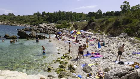 Crowdy-Cala-Mazzo-di-Sciacca-beach-near-Scopello,-Sicily-in-Italy