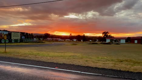 4K-UHD-Timelapse-of-orange-sky-sunrise,-Dark-low-clouds-in-Wallangarra,-QLD-NSW-border-town,-Queensland-Australia,-Old-time-commuter-train-line,-Country-life