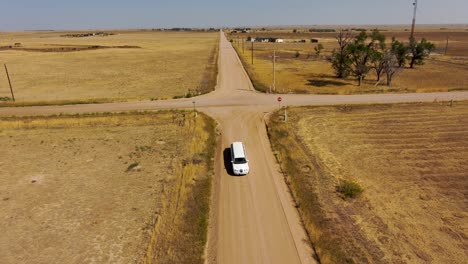 A-limousine-drives-down-a-country-road-in-4k-from-a-drone