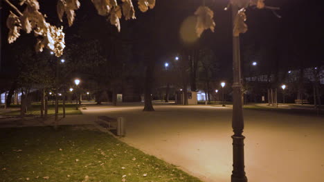 Empty-park-on-Strelecky-Island-at-night,Manes-bridge,streetlamps,Prague,Czechia