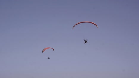 Two-Paraglider's-Flying-In-Tandem,-Recreational-Competitive-Sport