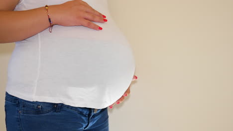 Massive-belly-with-a-baby-inside-of-young-mother,-side-static-view