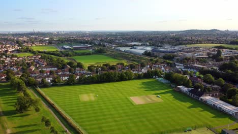 Aerial-shot-flying-over-a-city-sports-ground-and-recreational-park-in-summer