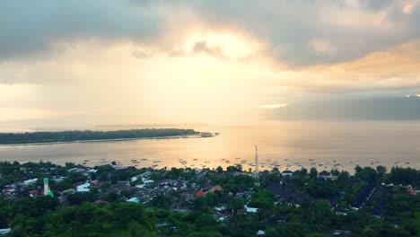Birds-eye-view-of-coastal-town-under-cloudy-sky-during-golden-hour