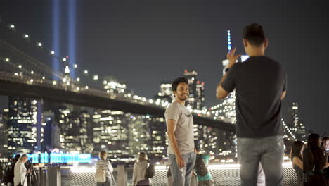 Man-Photographs-Friend-In-Front-Of-September-11th-Memorial-Lights-In-New-York-City