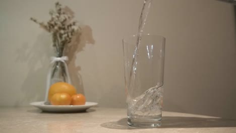 Pouring-clean-water-into-glass-slow-motion